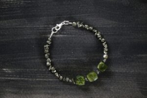 Close-up of an elegant stone bracelet showcasing textured beads and a metallic clasp.