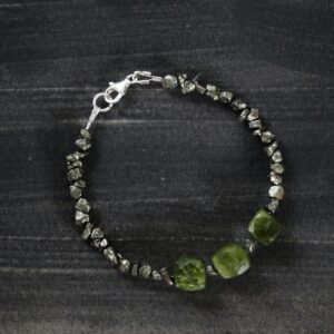 Close-up of an elegant stone bracelet showcasing textured beads and a metallic clasp.