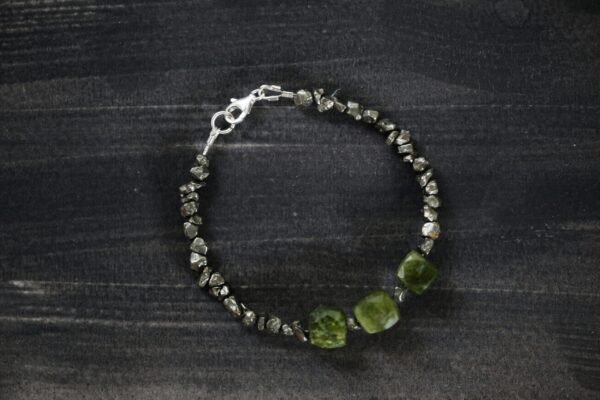 Close-up of an elegant stone bracelet showcasing textured beads and a metallic clasp.